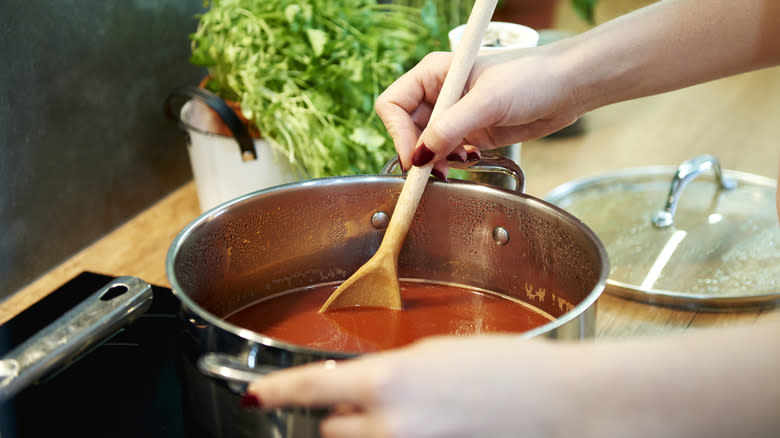 Hand stirring tomato soup 