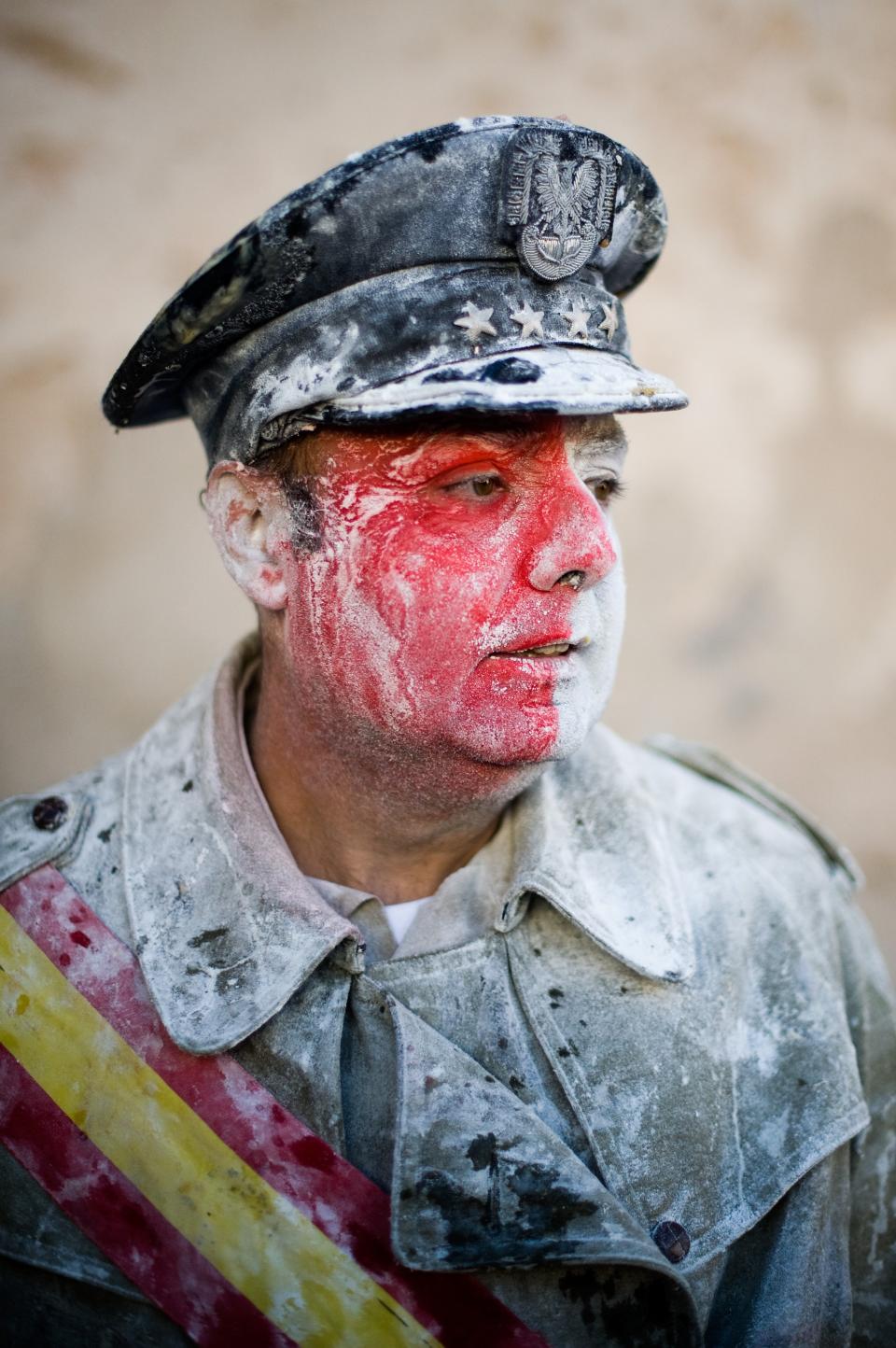 IBI, SPAIN - DECEMBER 28: A Reveller poses after taking part in the battle of 'Enfarinats', a flour fight in celebration of the Els Enfarinats festival on December 28, 2012 in Ibi, Spain. Citizens of Ibi annually celebrate the festival with a battle using flour, eggs and firecrackers. The battle takes place between two groups, a group of married men called 'Els Enfarinats' which take the control of the village for one day pronouncing a whole of ridiculous laws and fining the citizens that infringe them and a group called 'La Oposicio' which try to restore order. At the end of the day the money collected from the fines is donated to charitable causes in the village. The festival has been celebrated since 1981 after the town of Ibi recovered the tradition but the origins remain unknown. (Photo by David Ramos/Getty Images)