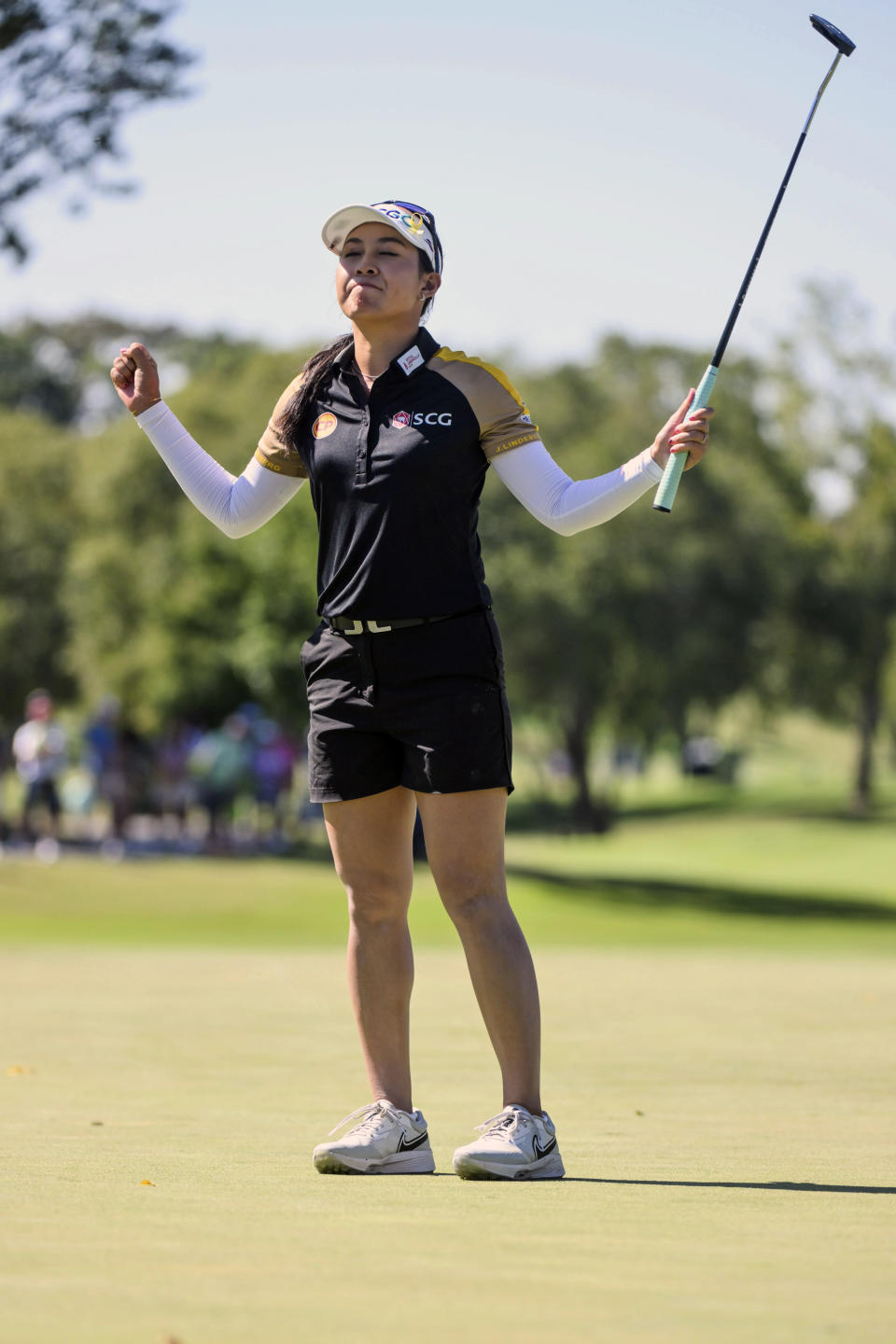 Atthaya Thitikul, of Thailand, reacts after making her winning putt on the 16th hole during a tie breaker round against Danielle Kang, of the United States, during the LPGA Walmart NW Arkansas Championship golf tournament, Sunday, Sept. 25, 2022, in Rogers, Ark. (AP Photo/Michael Woods)