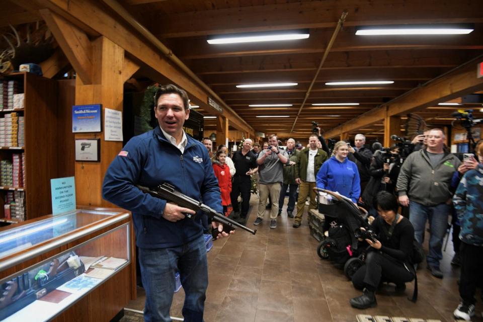 PHOTO: Republican presidential candidate Florida Governor Ron DeSantis checks out a Bonnie and Clyde gun during  a campaign stop at Sharp Shooters in Hooksett, N.H., Dec. 30, 2023.   (Faith Ninivaggi/Reuters)