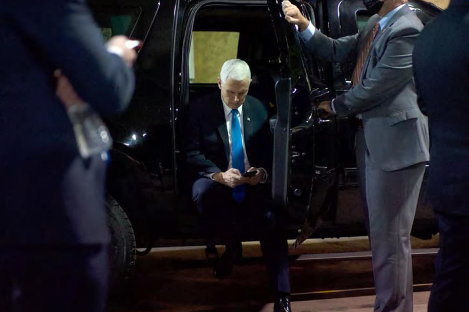 In this image released in the final report by the House select committee investigating the Jan. 6 attack on the U.S. Capitol, on Thursday, Dec. 22, 2022, Vice President Mike Pence looks at a mobile device from a secured loading dock at the U.S. Capitol on Jan. 6, 2021. (House Select Committee via AP)