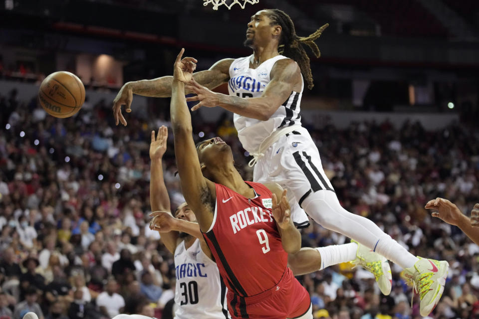 Orlando Magic's Emanuel Terry, right, blocks a shot by Houston Rockets' Josh Christopher during the second half an NBA summer league basketball game Thursday, July 7, 2022, in Las Vegas. (AP Photo/John Locher)