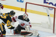 Pittsburgh Penguins' Bryan Rust (17) misses a shot against New Jersey Devils goaltender Nico Daws (50) during the first period of an NHL hockey game, Thursday, Feb. 24, 2022, in Pittsburgh. (AP Photo/Keith Srakocic)