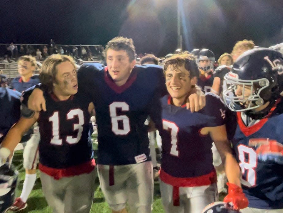 Lincoln-Sudbury captain Luke Ohler (6) is helped off the field by fellow seniors Jenson Martin (13) and Louie Stephan after the Warriors defeated Brockton on Sept. 22, 2023.