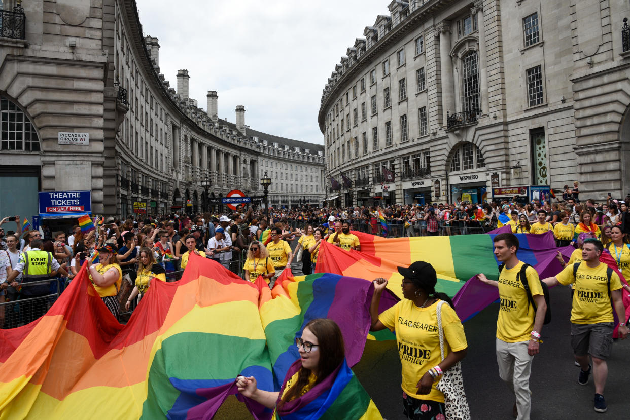 London, United Kingdom, July 6 2019: Happy lgbt people and supporters wearing colourful costumes with rainbow colors parading at the famous Pride Parade on the 6th of July at London, UK.