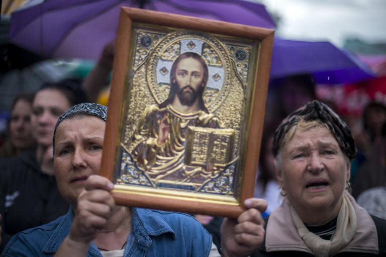 A woman holds an Orthodox icon during celebrations of what they claimed was resounding victory in an independence referendum in the eastern Ukrainian city of Lugansk, on May 12, 2014