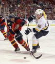 SUNRISE, FL - MARCH 03: Andrei Kostitsyn #46 of the Nashville Predators takes the shot as Jason Garrison #52 of the Florida Panthers checks him at the BankAtlantic Center on March 3, 2012 in Sunrise, Florida. The Predators defeated the Panthers 3-1. (Photo by Bruce Bennett/Getty Images)