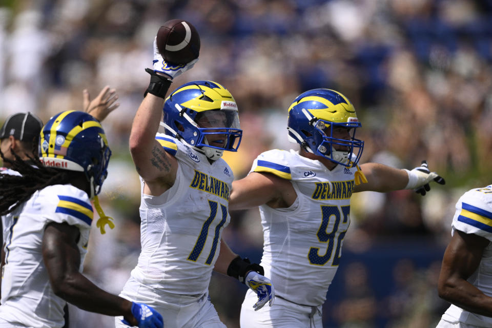 Delaware linebacker Liam Trainer (11) celebrates after he recovered a fumble during the first half of an NCAA college football game against Navy, Saturday, Sept. 3, 2022, in Annapolis, Md. Delaware defensive end Tommy Walsh (92) is at right. (AP Photo/Nick Wass)