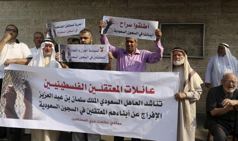 Families of Palestinians held in jails in Saudi Arabia, hold placards in Arabic that some read, "Release our sons in Saudi prisons, and No for the policy of isolation and torture for the prisoners in Saudi jails" during a protest, in front of the International Committee of the Red Cross office, in Gaza, Wednesday, Oct. 16, 2019. (AP Photo/Adel Hana)