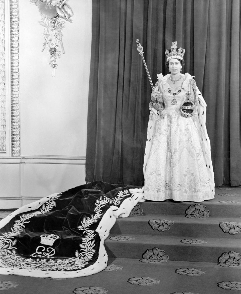 The Queen wearing the the Coronation dress and robe in the Throne Room at Buckingham Palace, after her Coronation in 1953 (PA) (PA Wire)