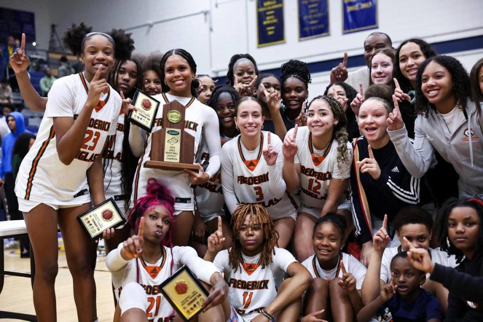 The Frederick Douglass girls team celebrates its victory over Henry Clay in the 42nd District Tournament championship game on Friday.