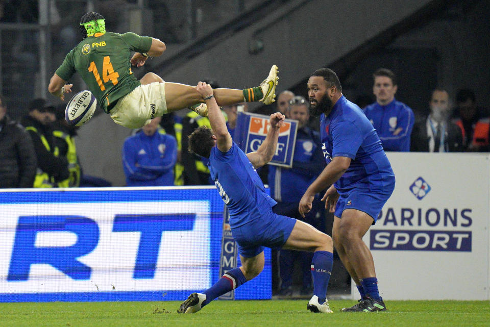 FILE - France's Antoine Dupont tackles South Africa's Cheslin Kolbe in midair during the rugby union international between France and South Africa in Marseille, France, Saturday, Nov. 12, 2022. (AP Photo/Daniel Cole, File)