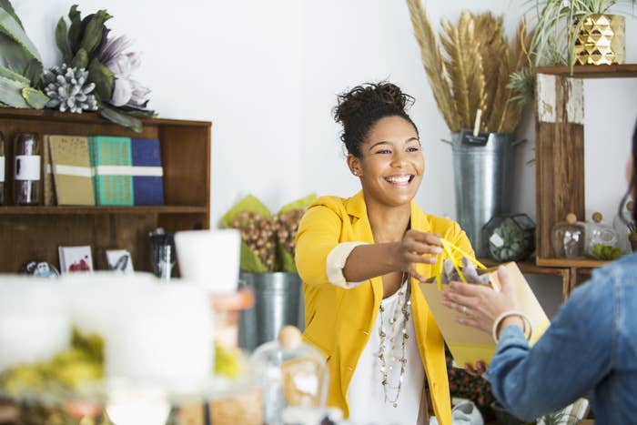 person giving a bag to customer