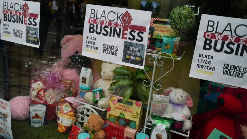 Signs in a shop window announce that the business is black-owned during a protest against police brutality. (Photo by Elijah Nouvelage/Getty Images)