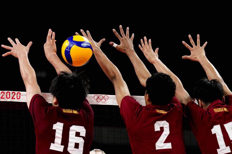 Volleyball players play during a rehearsal for the start of the volleyball preliminaries at Ariake Arena during the 2020 Summer Olympics, Friday, July 23, 2021, in Tokyo, Japan. (AP Photo/Frank Augstein)