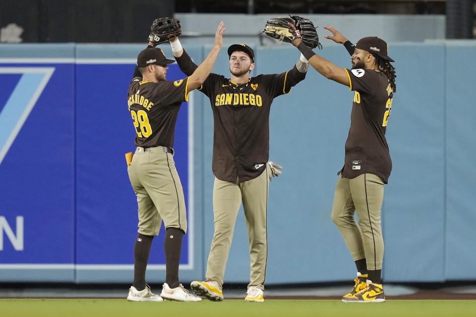 San Diego Padres outfielders Brandon Lockridge, left, Jackson Merrill, center, and Fernando Tatis Jr. celebrate after a win over the Los Angeles Dodgers in Game 2 of a baseball NL Division Series, Sunday, Oct. 6, 2024, in Los Angeles. (AP Photo/Mark J. Terrill)