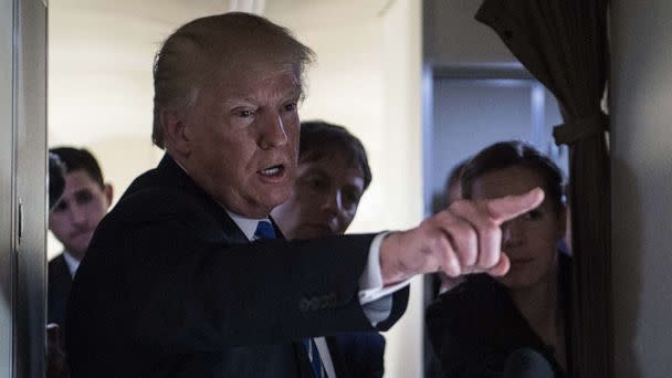 PHOTO: President Donald Trump speaks to reporters on board Air Force One as he travels back to Washington, Apr. 5, 2018. (Nicholas Kamm/AFP via Getty Images)