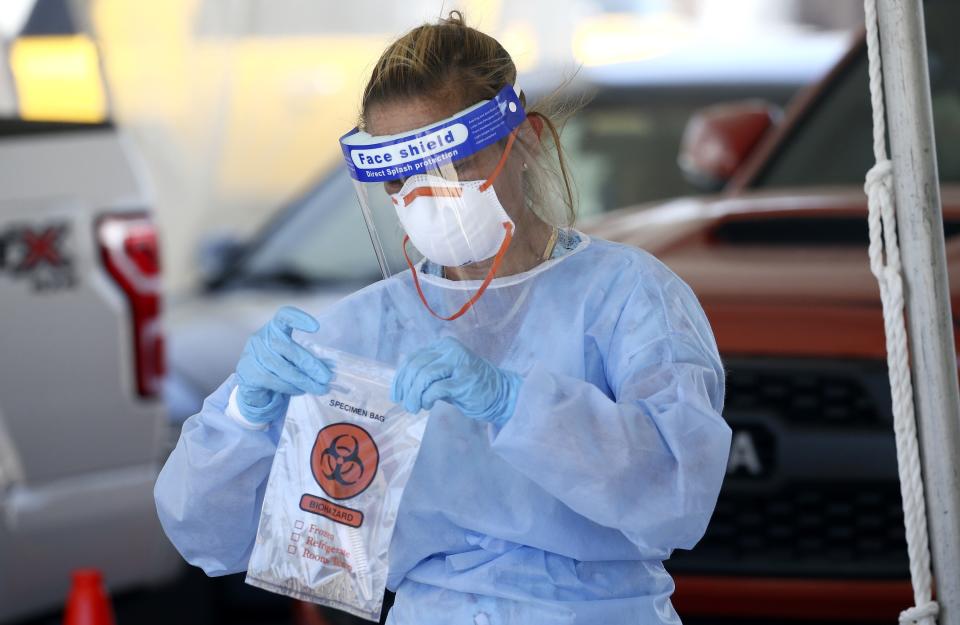 A specimen is secured at a drive-thru coronavirus testing site at South Mountain Community College on July 9, 2020, in Phoenix. (Ross D. Franklin/AP)