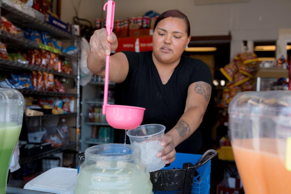 Michelle Jaquez from 703 Sabroso Shop prepares a limonada for a customer on a hot day in Downtown El Paso on Tuesday.
