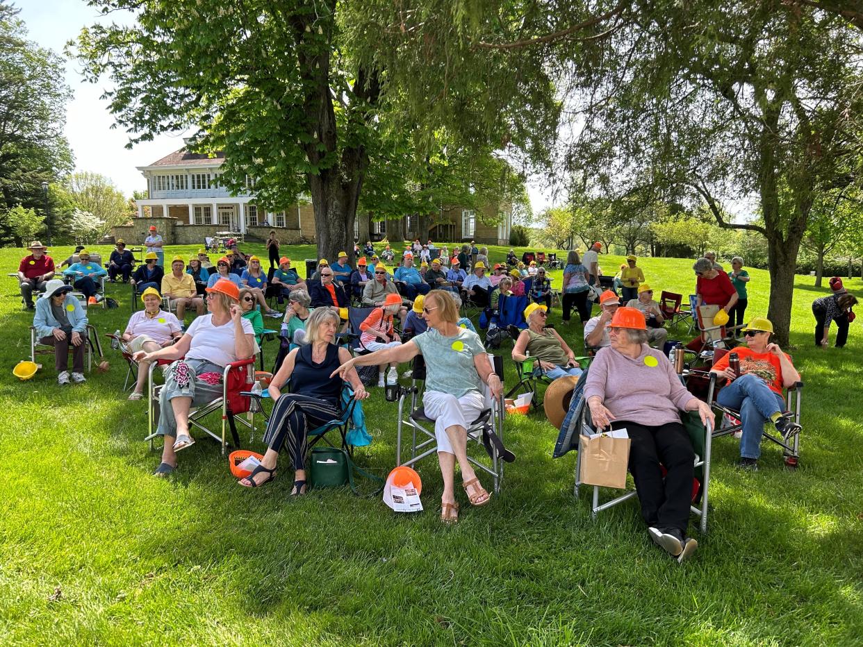 Members of the Licking County Community Center for 60+ Adults sit on the lawn of the Bryn Du Mansion during a groundbreaking ceremony May 1 for a $1.5 million renovation of the historic barn at the Bryn Du Mansion. Community Center members matched the theme as they wore plastic hard hats.