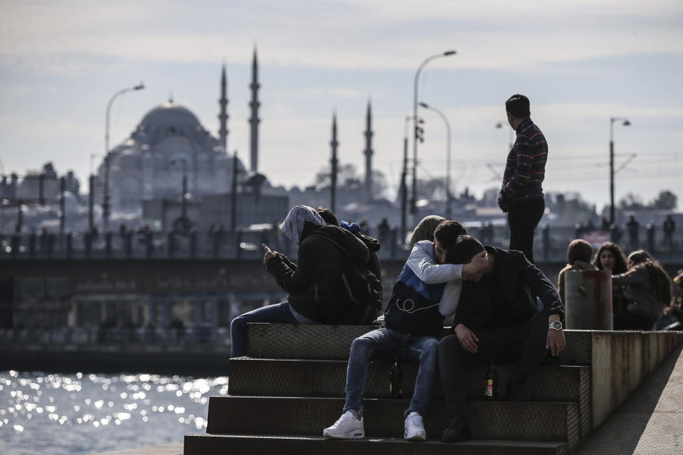 Backdropped by the Suleymaniye mosque, people sit by the Golden Horn in Istanbul, Monday, April 1, 2019, a day after the local elections. Turkey's opposition dealt Erdogan a symbolic blow by gaining ground in key cities in the country's local elections. The opposition won the capital, Ankara, a ruling party stronghold for decades, and was leading a tight race for mayor in Istanbul, according to unofficial figures Monday. (AP Photo/Emrah Gurel)