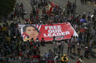 Demonstrators display a banner with an image of deposed Myanmar leader Aung San Suu Kyi during a protest against the military coup in Yangon, Myanmar, Wednesday, Feb. 17, 2021. The U.N. expert on human rights in Myanmar warned of the prospect for major violence as demonstrators gather again Wednesday to protest the military's seizure of power. (AP Photo)