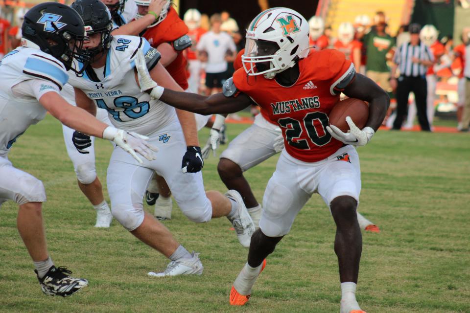Mandarin running back Tiant Wyche (20) wards off a tackle against Ponte Vedra in preseason.