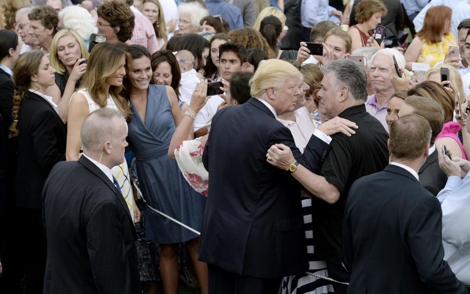 Donald Trump and First Lady Melania Trump greet the guests at the Congressional Picnic - Credit: Pool/ Getty Images North America