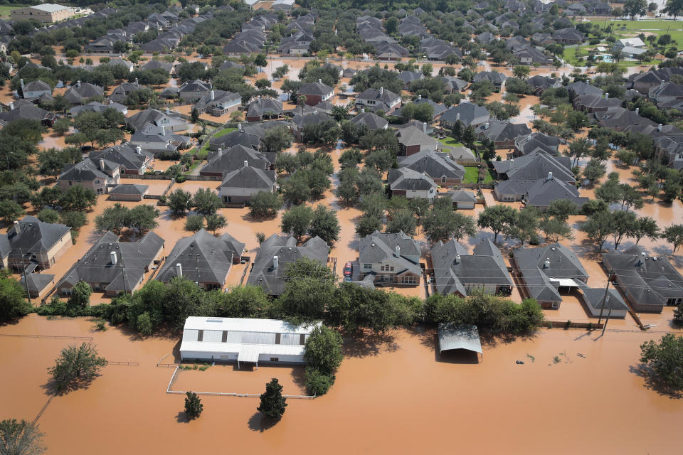 Homes are surrounded by floodwater after torrential rains pounded Southeast Texas.