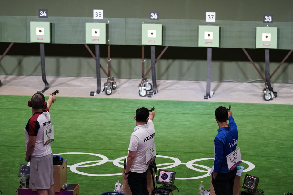 Christian Reitz, left, of Germany, Jongoh Jin, of South Korea, and Abhishek Verma, of India, compete in the men's 10-meter air pistol at the Asaka Shooting Range in the 2020 Summer Olympics, Saturday, July 24, 2021, in Tokyo, Japan. (AP Photo/Alex Brandon)