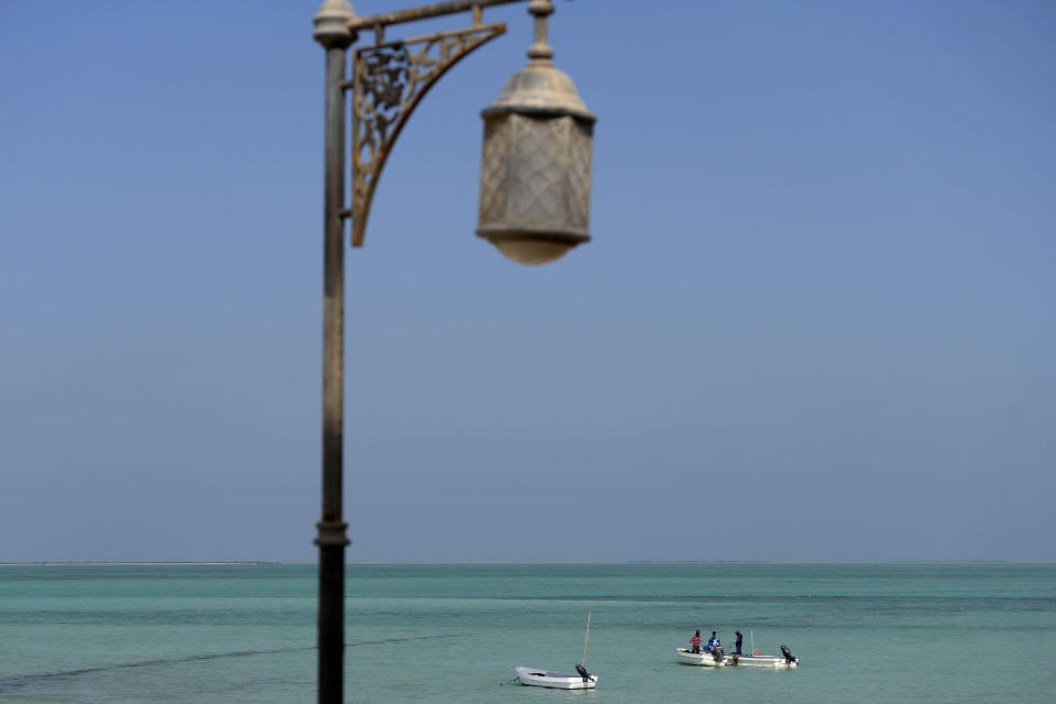 Fisher work on their boats in Al-Ruwais, Qatar, Friday, Dec. 2, 2022. (AP Photo/Matthias Schrader)