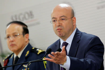 National Security Commissioner Renato Sales (R) gives a speech to the media during a news conference about of Felipe Flores, a former police chief of Iguala who was detained in Iguala on Friday, at the interior ministry in Mexico City, Mexico October 21, 2016. REUTERS/Henry Romero