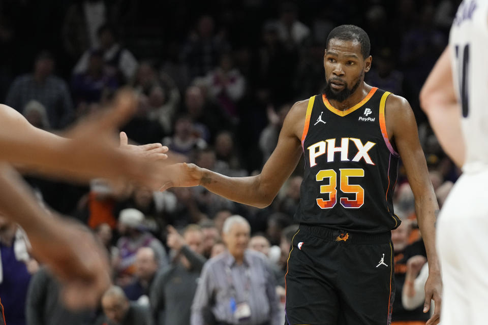 Phoenix Suns forward Kevin Durant celebrates his 3-pointer against the Sacramento Kings during the second half of an NBA basketball game Tuesday, Jan. 16, 2024, in Phoenix. The Suns won 119-117. (AP Photo/Ross D. Franklin)