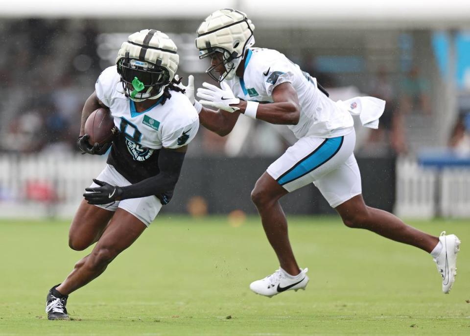 Carolina Panthers cornerback Jaycee Horn, left, runs upfield after catching a ball during practice on Tuesday, August 6, 2024.