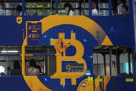 FILE - This May 12, 2021, file photo shows an advertisement for the cryptocurrency Bitcoin displayed on a tram in Hong Kong. Bitcoin is one of several cryptocurrencies that radical right provocateurs, banned by traditional financial institutions, are using to raise significant amounts of money and move it around the world. (AP Photo/Kin Cheung, File)