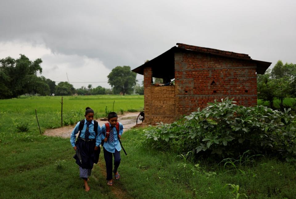 Parwati and Resham set off on their walk to school (Reuters)