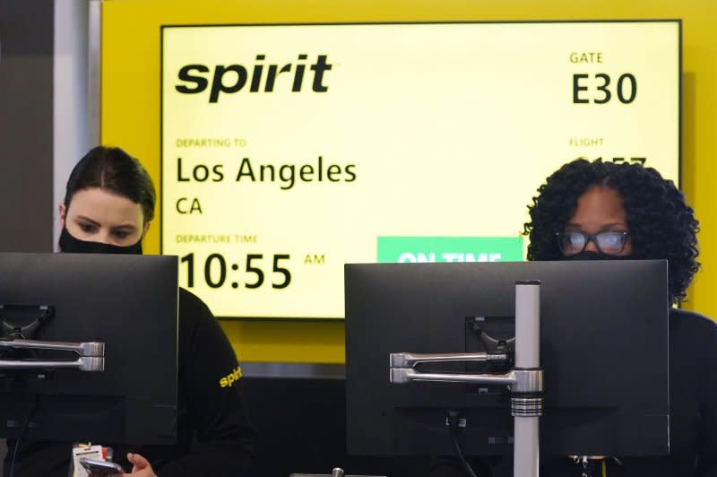 Spirit Airlines agents work behind the counter in May 2021 on day one of their service to St. Louis at St. Louis Lambert International Airport. "Today marks the beginning of a new era for Frontier -- one with transparency in our prices, no change fees and the lowest total price," Barry Biffle, Frontier Airlines CEO said Friday in the company statement outlining the new changes. File Photo by Bill Greenblatt/UPI