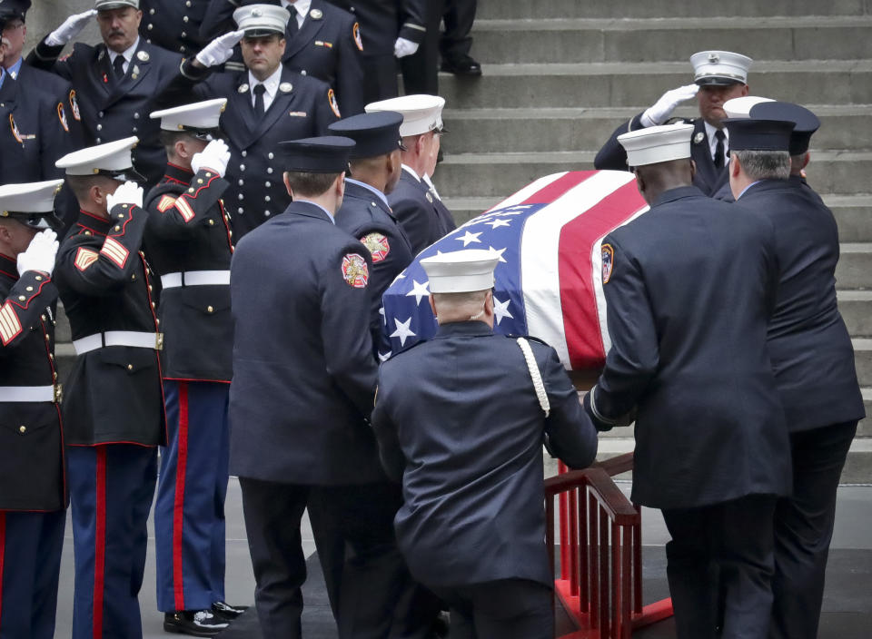 Fire and military officials salute the casket for U.S. Marine Corps Staff Sergeant and FDNY Firefighter Christopher Slutman, as it arrives for funeral service at St. Thomas Episcopal Church, Friday April 26, 2019, in New York.The father of three died April 8 near Bagram Airfield U.S military base in Afghanistan. (AP Photo/Bebeto Matthews)