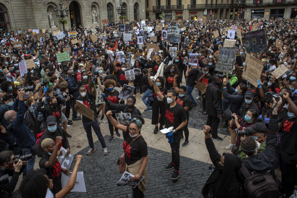 People gather in Barcelona, Spain, Sunday, June 7, 2020, during a demonstration over the death of George Floyd, a black man who died after being restrained by Minneapolis police officers on May 25. (AP Photo/Emilio Morenatti)