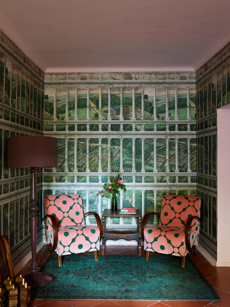 pink chairs in a wallpapered corner