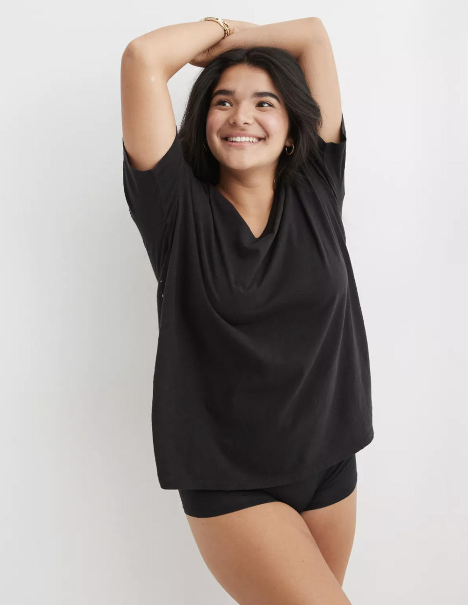 Model posing in black tee with booty shorts