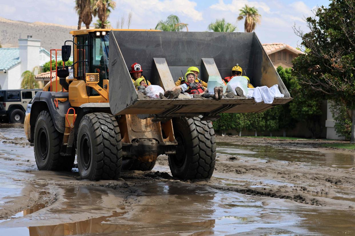 Cathedral City Fire Department rescues residents in a bulldozer following heavy rains from Tropical Storm Hilary in Cathedral City, California, on August 21, 2023 (AFP via Getty Images)