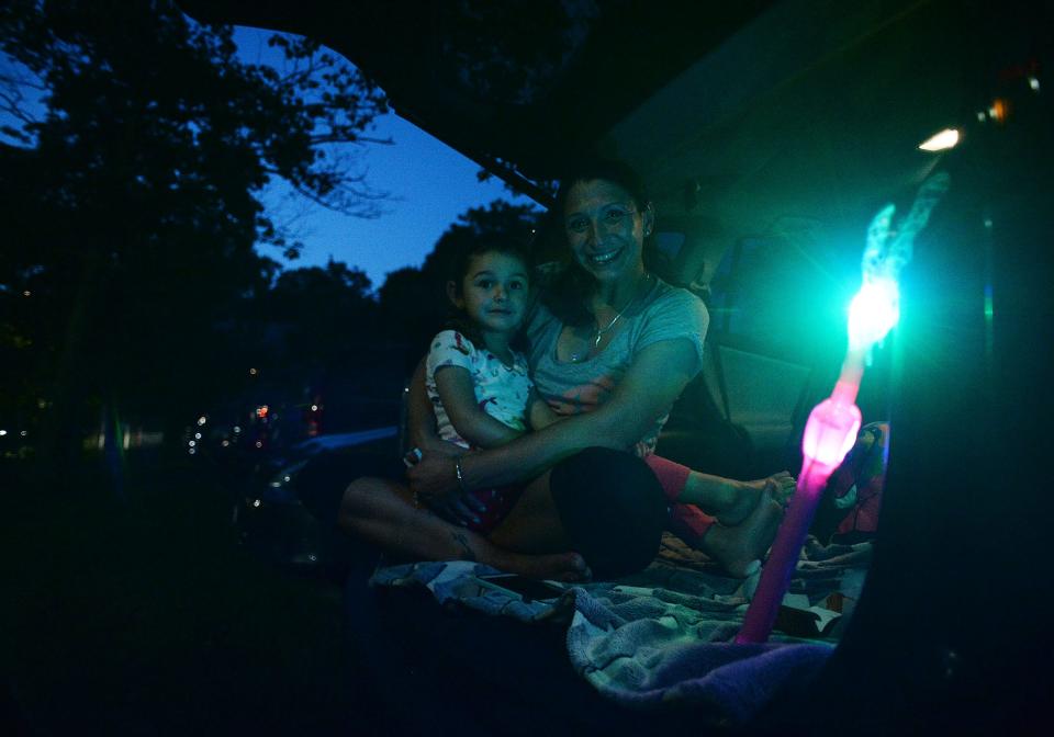 Jima Ciambriello and her daughter Risuba Ciambriello, 3, wait for the fireworks during the Summer Celebration at Hopewell Park in Taunton on Friday, Aug. 27, 2021.