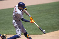 Houston Astros shortstop Carlos Correa hits a single in the fourth inning of a baseball game against the Minnesota Twins, Sunday, June 13, 2021, in Minneapolis. (AP Photo/Andy Clayton-King)