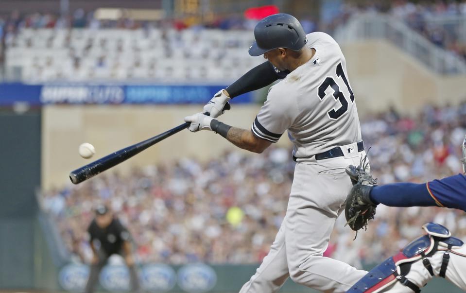 New York Yankees' Aaron Hicks hits an RBI single off Minnesota Twins pitcher Jake Odorizzi in the fourth inning of a baseball game Wednesday, July 24, 2019, in Minneapolis. (AP Photo/Jim Mone)