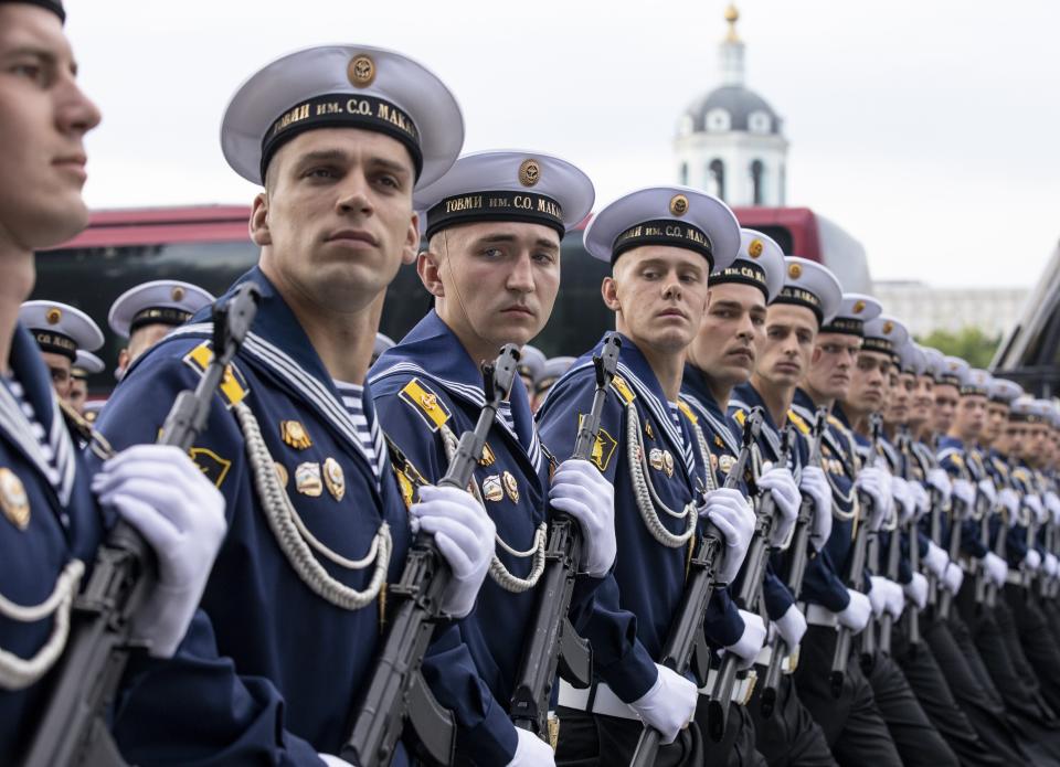 FILE - In this file photo taken on Saturday, June 20, 2020, Russian sailors march toward Red Square to attend a dress rehearsal for the Victory Day military parade in Moscow, Russia. A massive military parade that was postponed by the coronavirus will roll through Red Square this week to celebrate the 75th anniversary of the end of World War II in Europe, even though Russia is continuing to register a steady rise in infections. (AP Photo/Alexander Zemlianichenko, File)