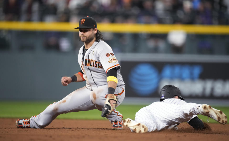 San Francisco Giants shortstop Brandon Crawford is late with the tag as Colorado Rockies' Brenton Doyle steals second base during the sixth inning of a baseball game Friday, Sept. 15, 2023, in Denver. (AP Photo/David Zalubowski)