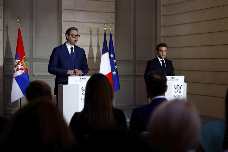 French President Emmanuel Macron, right, and Serbian President Aleksandar Vucic deliver a joint statement before a working dinner at the Elysee Palace in Paris, Monday, April 8, 2024. (Sarah Meyssonnier/Pool via AP)