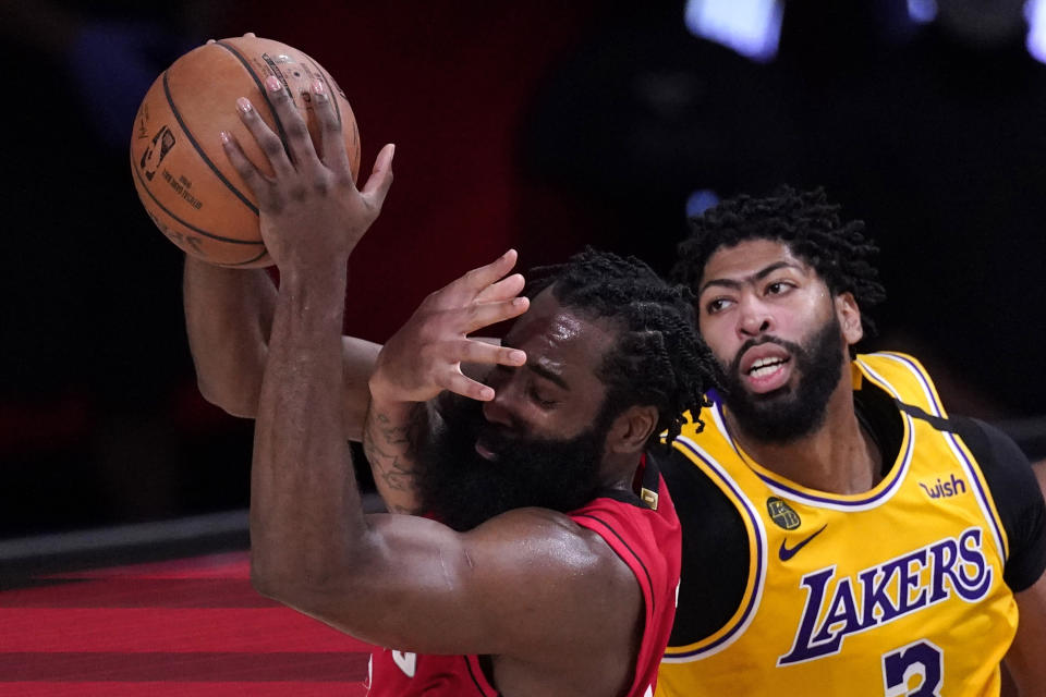 Los Angeles Lakers' Anthony Davis (3) defends against Houston Rockets' James Harden during the second half of an NBA conference semifinal playoff basketball game Thursday, Sept. 10, 2020, in Lake Buena Vista, Fla. The Lakers won 110-100. (AP Photo/Mark J. Terrill)