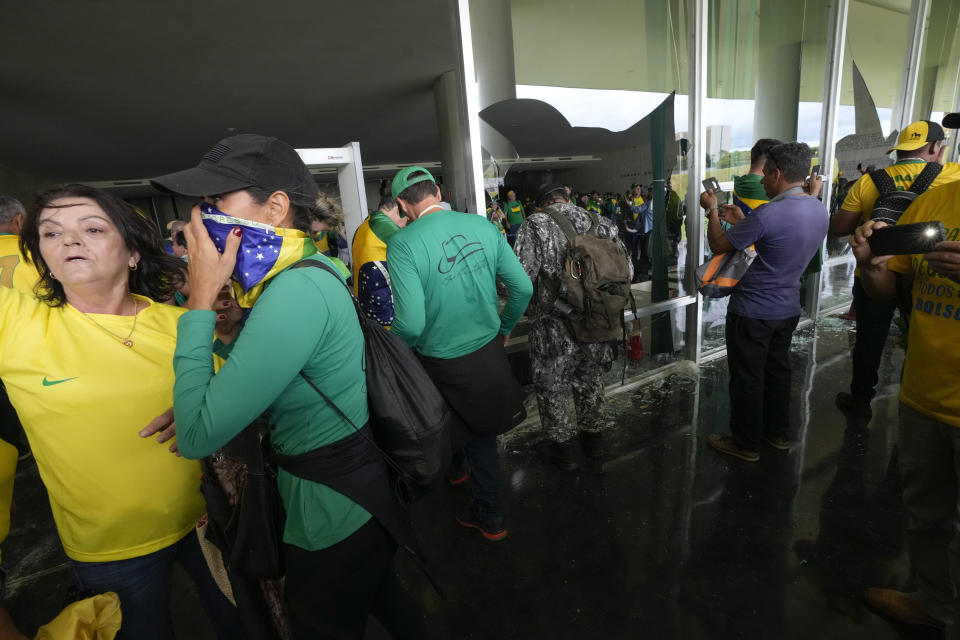 Protesters, supporters of Brazil's former President Jair Bolsonaro, storm the the National Congress building in Brasilia, Brazil, Sunday, Jan. 8, 2023. (AP Photo/Eraldo Peres)